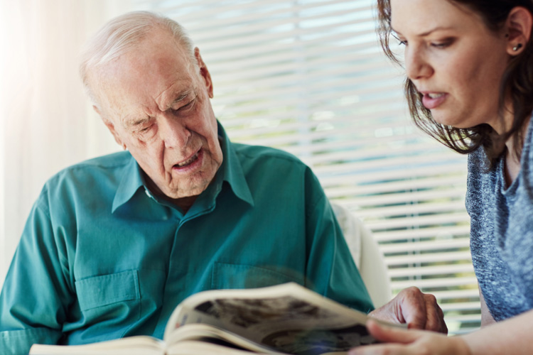 Clermont Park Senior Living Community in Denver, CO - clermont park adult daughter reading to senior father