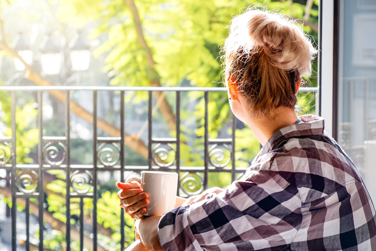 Clermont Park Senior Living Community in Denver, CO - clermont park adult caregiver looking out of window