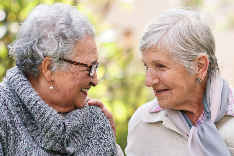 Clermont Park Senior Living Community in Denver, CO - two older women talking and smiling