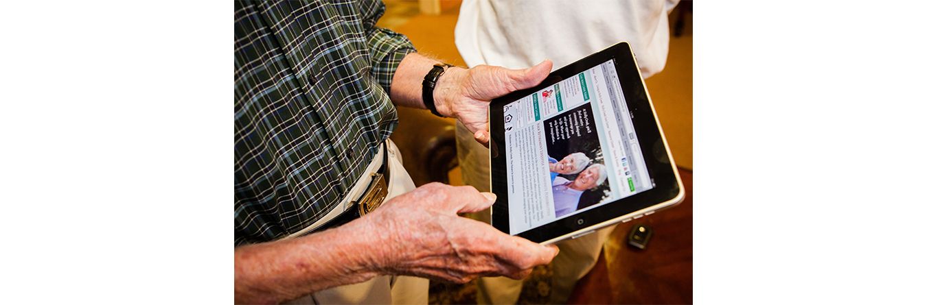 Elderly man using tablet for information