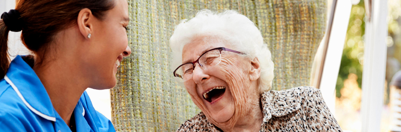 Older adult and care partner talking and laughing