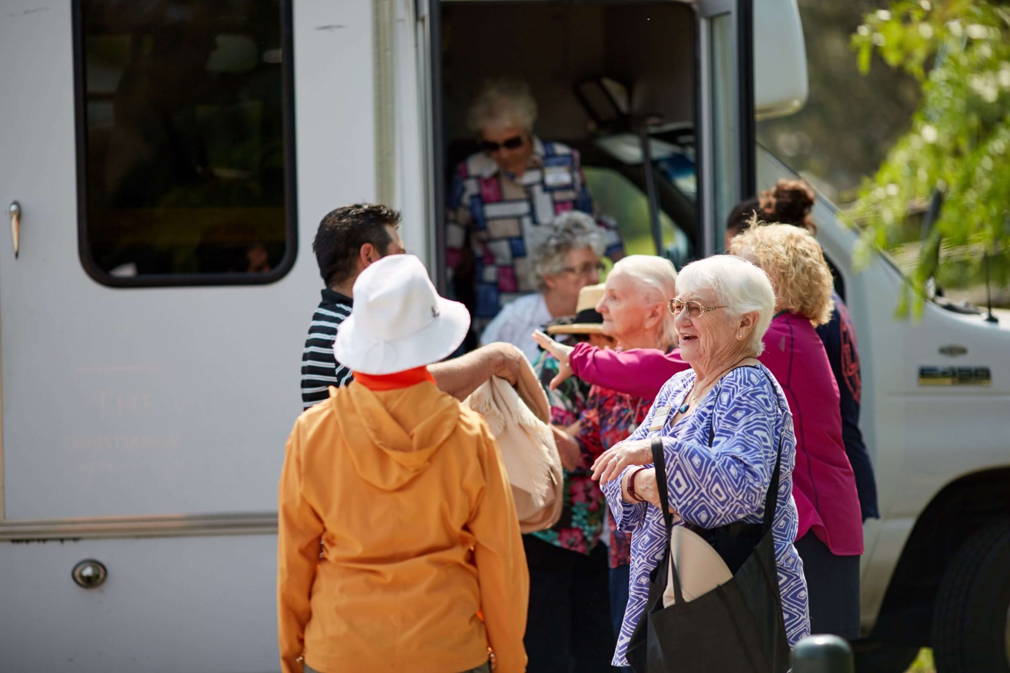 Clermont Park Senior Living Community in Denver, CO - older adults standing by community van