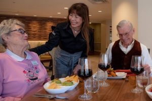 Clermont Park Senior Living Community in Denver, CO - dining team member and residents smiling