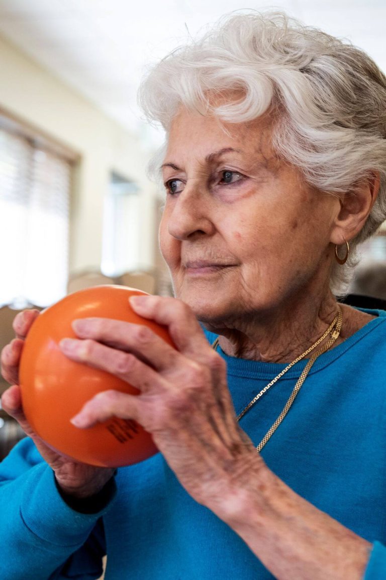Clermont Park Senior Living Community in Denver, CO - older woman holding exercise ball