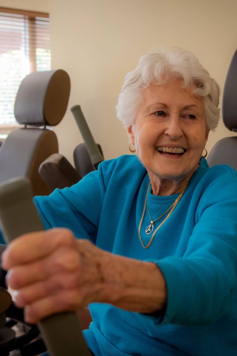 Clermont Park Senior Living Community in Denver, CO - older woman smiles while exercising