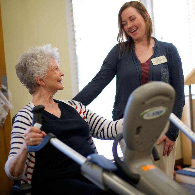 Clermont Park Senior Living Community in Denver, CO - physical therapist and older woman talking square