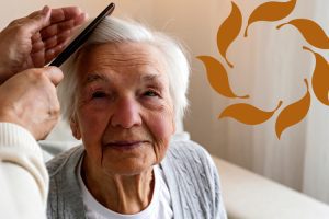 Clermont Park Senior Living Community in Denver, CO - older adult women smiling as her hair is combed