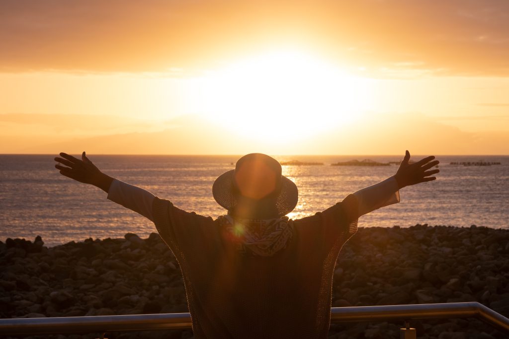 Clermont Park Senior Living Community in Denver, CO - rear,view,of,woman,silhouette,admiring,the,orange,sunset,over