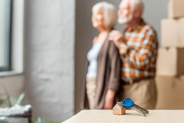 Clermont Park Senior Living Community in Denver, CO - house keys with senior couple in the background