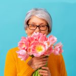 Clermont Park Senior Living Community in Denver, CO - aging in place senior woman holding bouquet of tulips