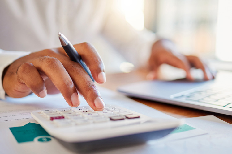 Clermont Park Senior Living Community in Denver, CO - close up of hands using calculator