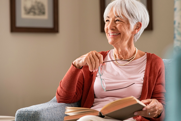 Clermont Park Senior Living Community in Denver, CO - senior woman with a book