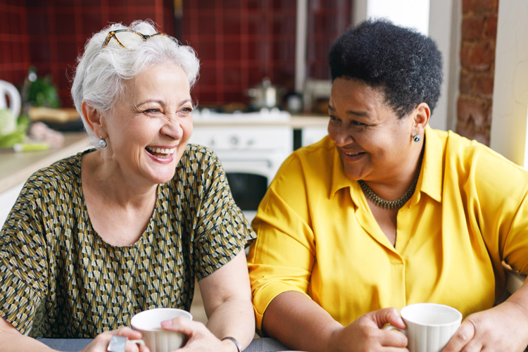 cp two senior women talking over coffee Clermont Park Senior Living Community in Denver, CO - cp two senior women talking over coffee