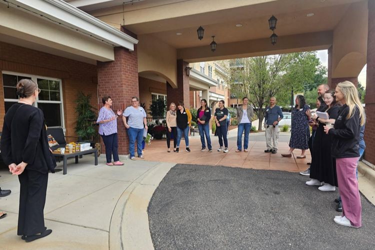 residents and team members gathering at the suites at clermont park patio Clermont Park Senior Living Community in Denver, CO - residents and team members gathering at the suites at clermont park patio