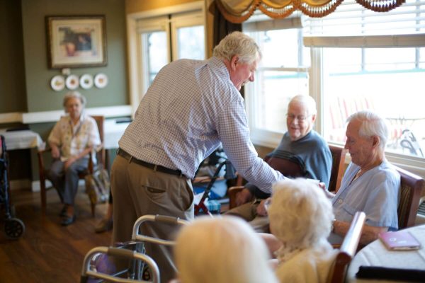 Clermont Park Senior Living Community in Denver, CO - older adults gather in community room