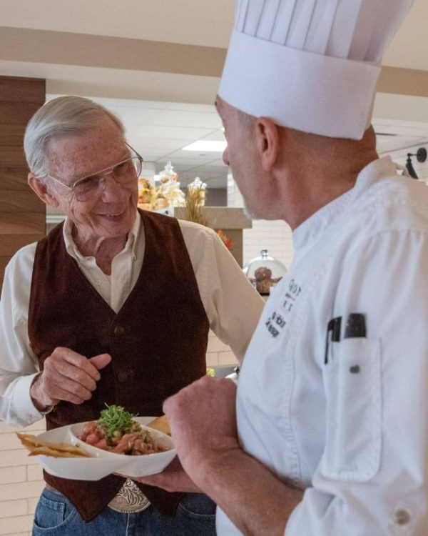 Clermont Park Senior Living Community in Denver, CO - older man and chef discuss meal square