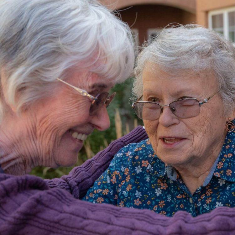 Clermont Park Senior Living Community in Denver, CO - two older women smiling and talking