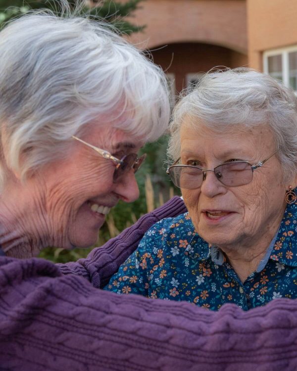 Clermont Park Senior Living Community in Denver, CO - two older women smiling and talking